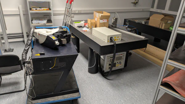 Optical table with pulsed laser on top.